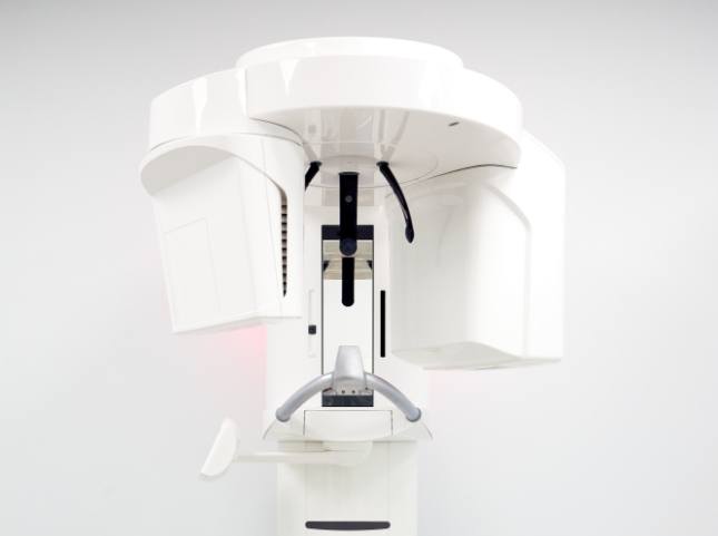 Cone beam imaging device standing against white wall