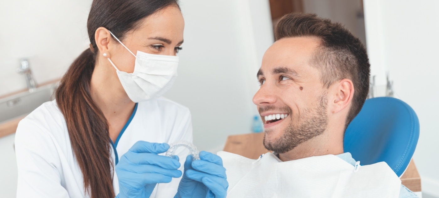 Dentist showing a patient a clear aligner
