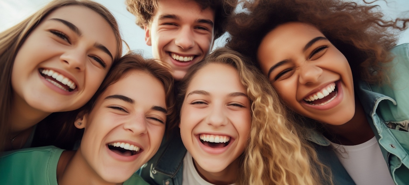 Five teenagers smiling outdoors after tooth extractions in Dublin