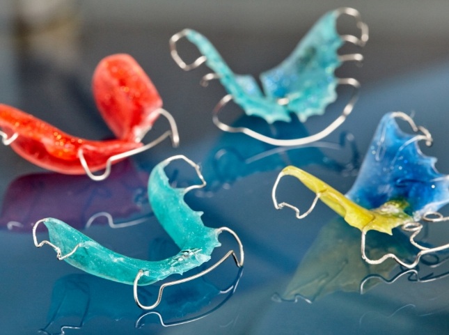 Several retainers with different colors on tray