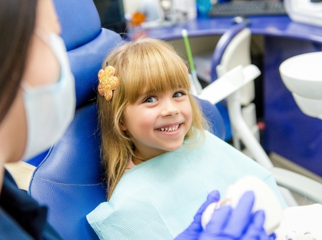 Young girl grinning in dental chair