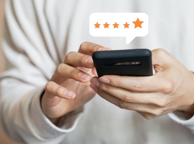 Person leaving a five star review on their phone