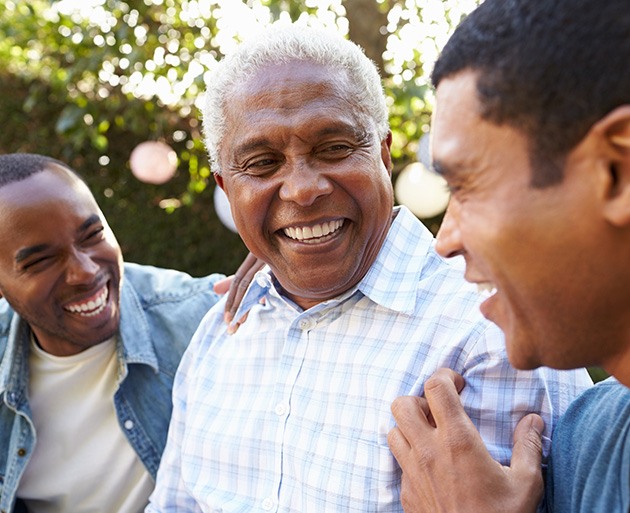 Patient in Dublin smiling with family after getting new dentures