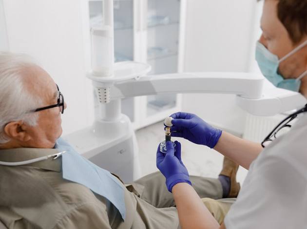 a dentist explaining dental implants to a patient