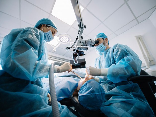 an oral surgeon performing dental implant surgery
