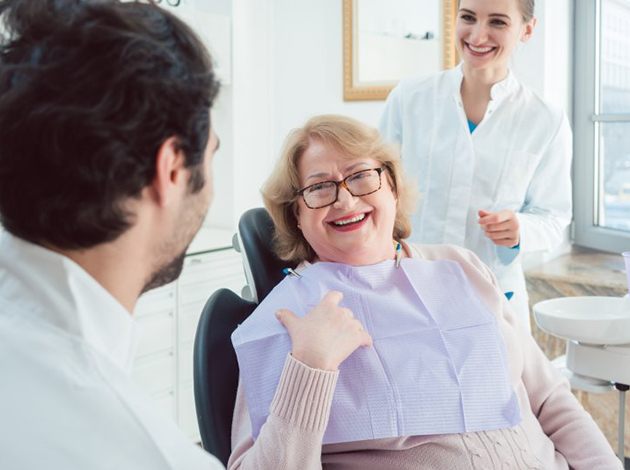 Woman visiting dentist and smiling