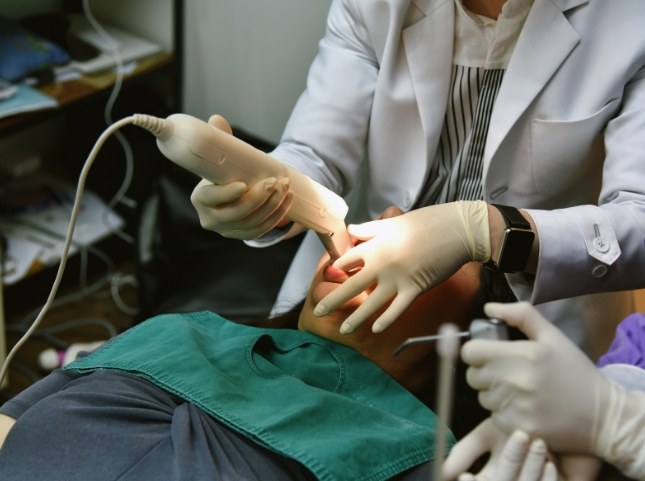 Dentist taking digital impressions of a patient