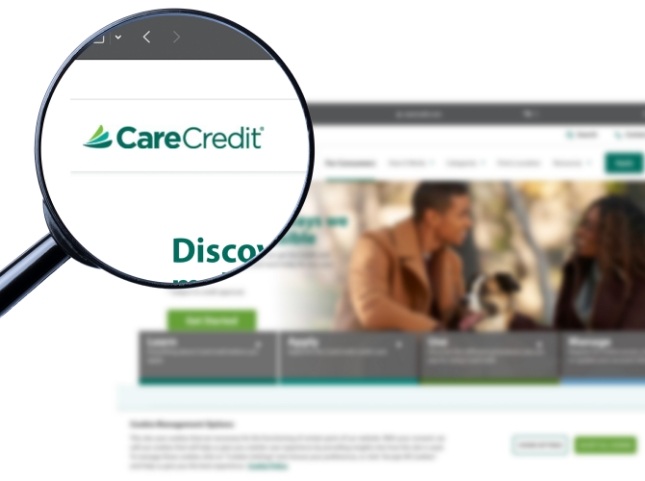 Magnifying glass showing the Care Credit logo on their website