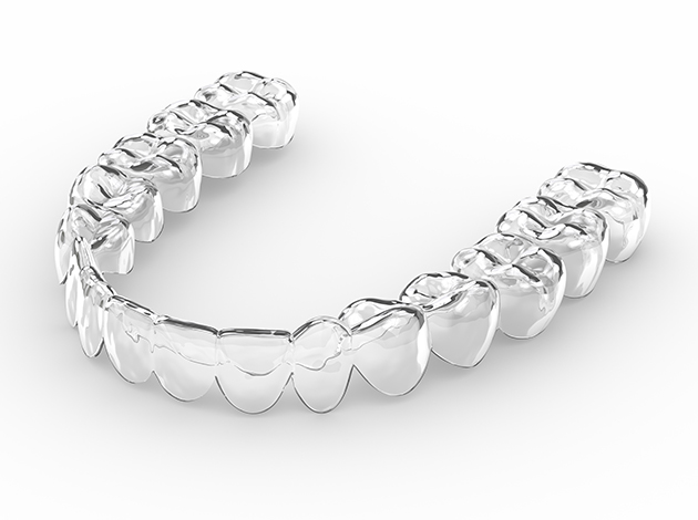 Closeup of clear aligner on white surface