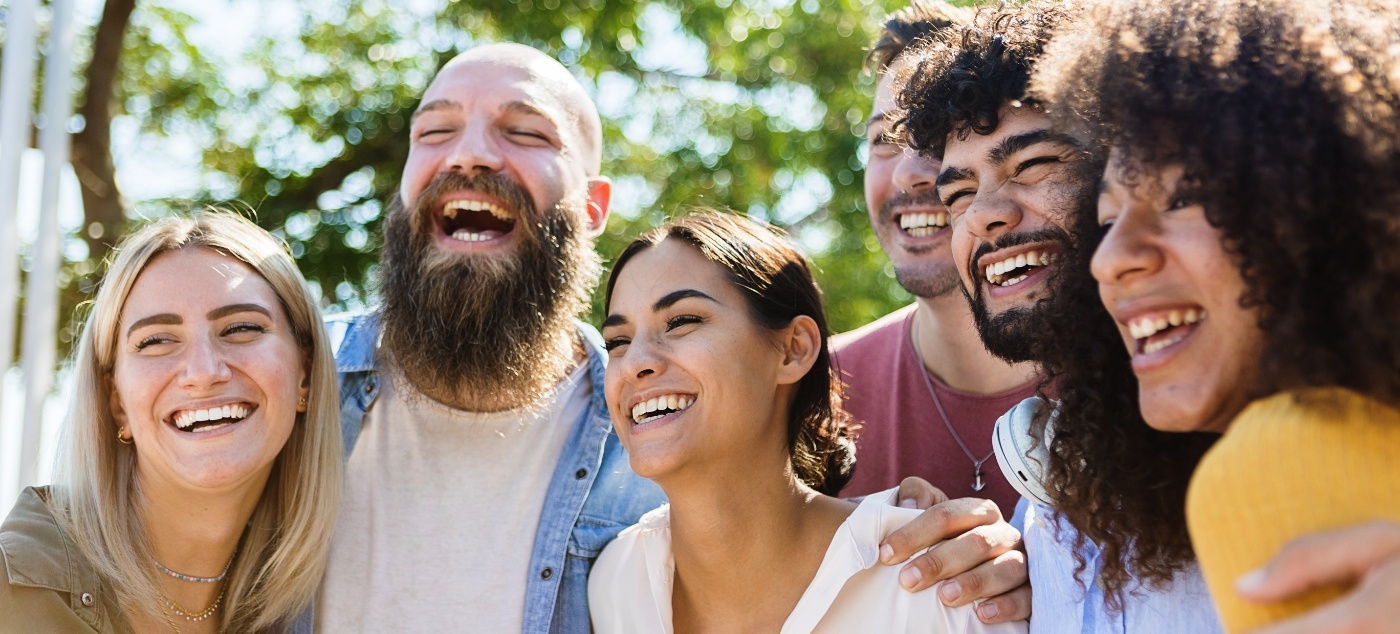 Group of people laughing outdoors after dental services in Dublin