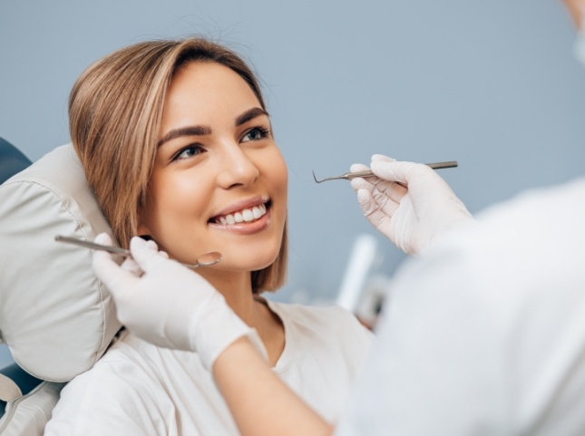 Woman smiling during preventive dentistry checkup