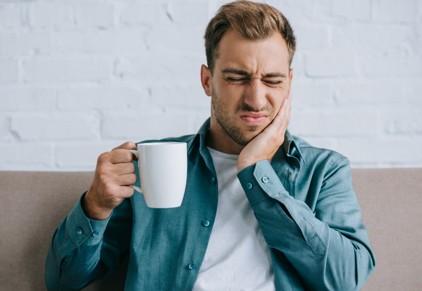 Man holding jaw in pain
