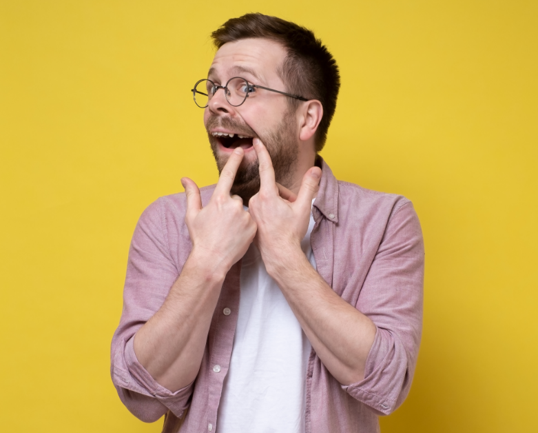 Man pointing at missing tooth