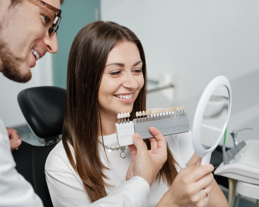 Dentist showing patient veneers